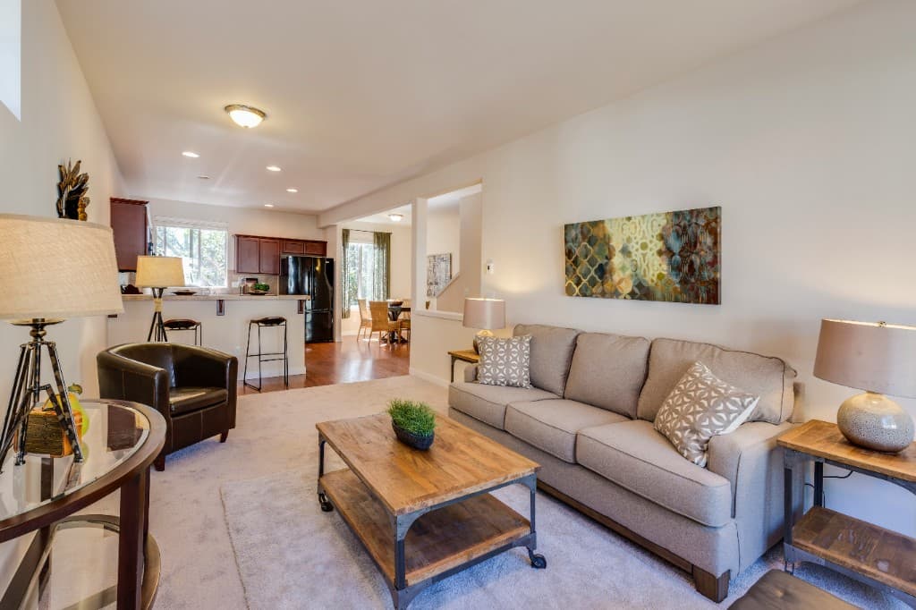 Furnished living room opening to a kitchen